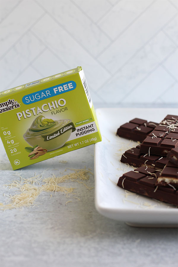 Chocolate bars with pistachio pudding filling beside Simply Desserts Pistachio Pudding mix box